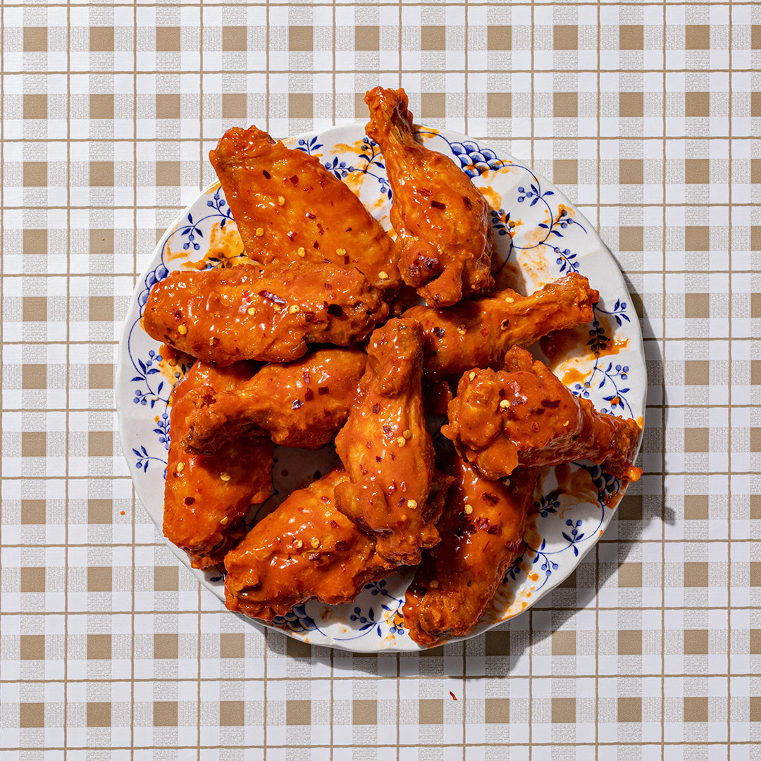 A plate of Nashville Hot Wings - the definition of mouthwatering, our hottest style wing packing some real fire balanced with the perfect touch of tangy vinegar goodness. Available boneless or bone in 